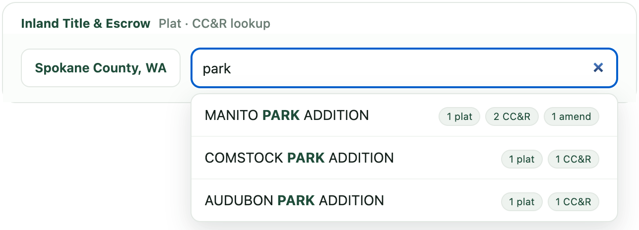 The SubdivisionIQ search bar with ranked suggestions for Spokane County